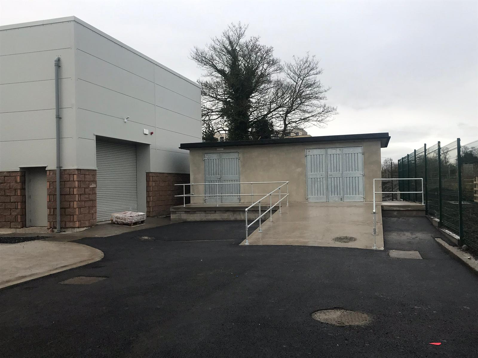 A commercial unit with a new tarmac yard, ramp and handrail