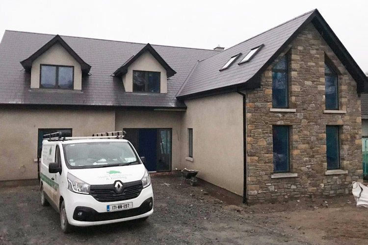 A new build house with stone and render elevations and dormer windows