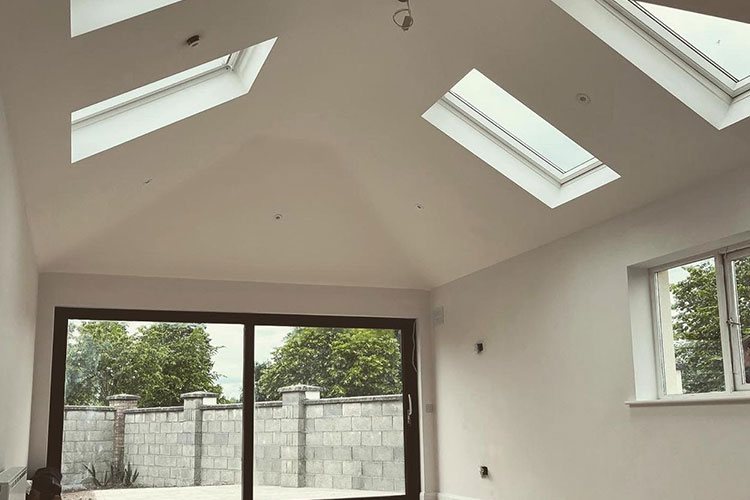A converted roof space with a vaulted ceiling and rooflights